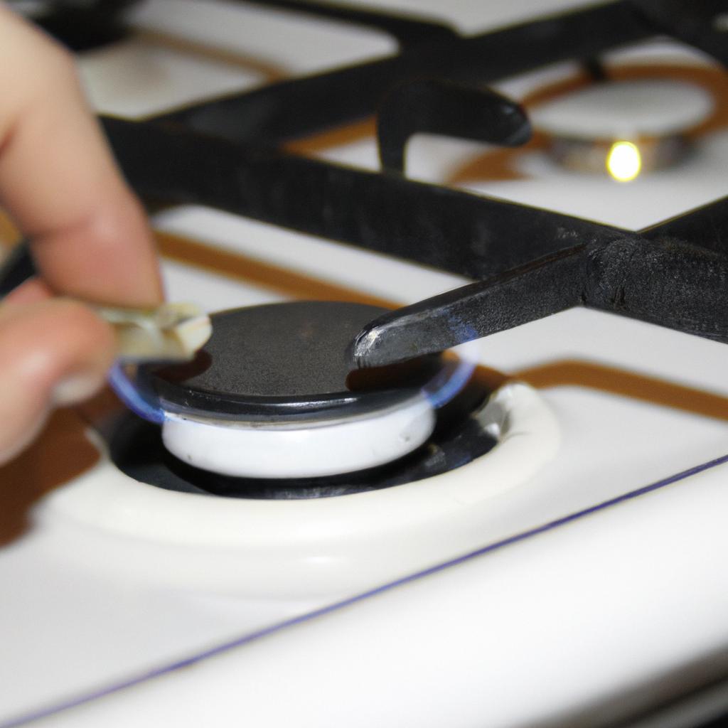 Person cleaning gas appliance burner