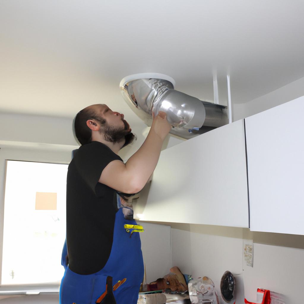 Man installing ductwork in kitchen