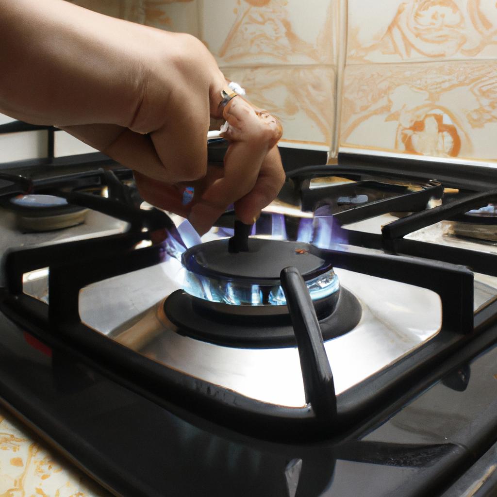 Person adjusting gas stove flame