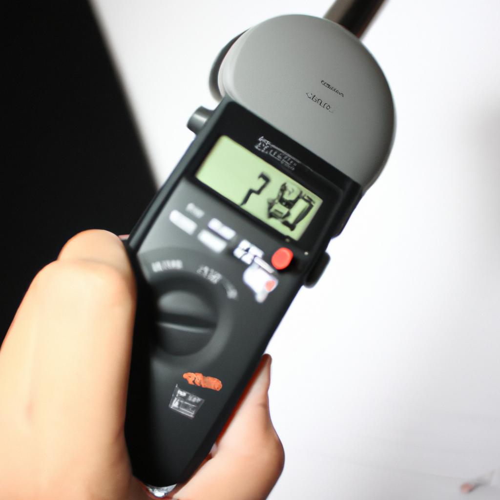 Person measuring noise levels, adjusting